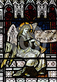 Angel making music (playing trumpet) in stained glass