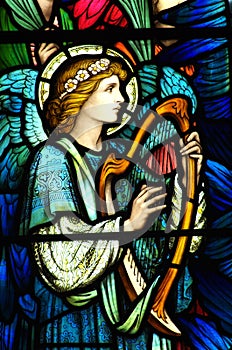 An angel making music in stained glass