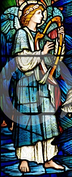 An angel making music in stained glass