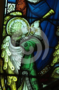 Angel making music with a trumpet (stained glass)