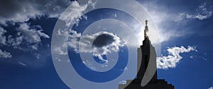 Angel Moroni on Top of Mormon LDS Temple with Sky and Clouds Sunstar Bright Holy Light photo