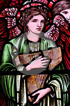 An angel with a music instrument in stained glass