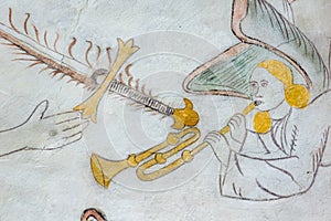 Angel playing the trumpet, medieval wall-painting photo