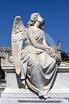 An angel sits on a grave at the Roman Catholic Cementerio la Reina cemetery in Cienfuegos, Cuba photo