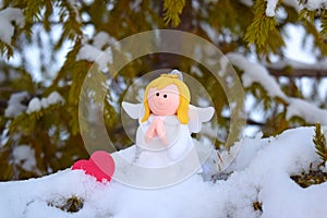 An angel on a snow-covered Christmas tree.