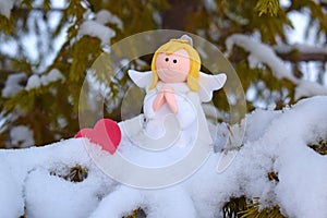 An angel on a snow-covered Christmas tree. photo
