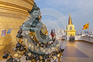 Angel statue with Golden stupa, Wat Saket or Golden Mount in Bangkok, Thailand