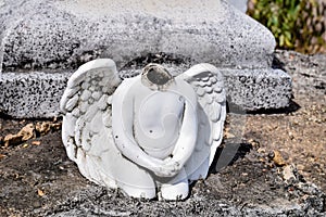 Angel statue without a head on a cemetery