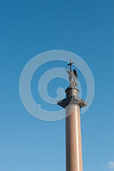 Angel statue holding cross in St. Petersburg with moon