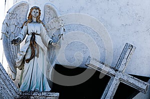 angel statue open arms and cross with copy space