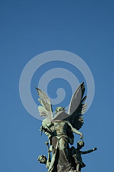 Angel statue with wings on a blue sky