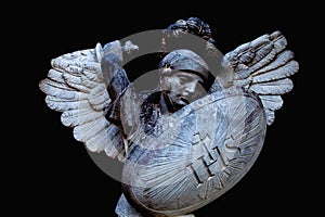 Angel struggles with evil. Fragment of antique statue. Good triumphs over evil concept