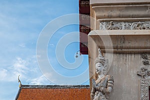 The angel stucco sculpture on the wall corner of the buddhist chapel temple