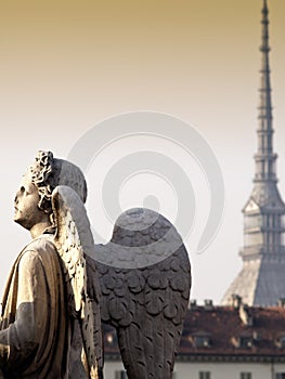 Angel at sunset watching the city of Turin, Italy