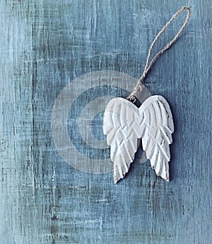 Angel Wings on hand painted, wooden background.