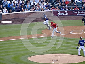 Angels batter Albert Pujols runs with Rockies catcher towards first base