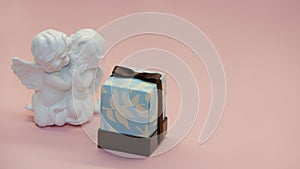 Angels and a gift on a pink background