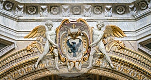 Angels supporting a bishop coat of arms, in the Basilica of Santa Maria del Popolo in Rome, Italy.
