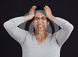 Anger, anxiety and senior woman screaming, depression and mental health issue on a dark studio background. Person