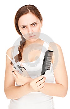 Anger hairdresser holding a scissors and comb isolated (focus o