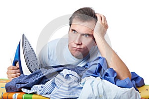 Anger man with pile of laundry before ironing isolated