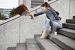 Anger, stairs and business with woman in city for unemployment, job loss and crisis. Problem, stress and fear with