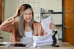 Angered and mad Asian businesswoman screams and dissatisfies with her assistant`s work