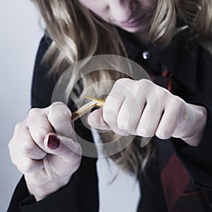 Angers, stressed and frustrated business woman breaking pencil a