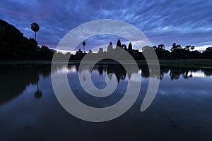 Angkor Wat and blue sky reflected in the lake at sunrise, view of popular tourist attraction ancient temple in Siem Reap, Cambodia