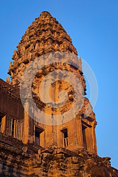 Angkor Wat, in Cambodia. Low angle view of one of the central towers at sunset against blue sky