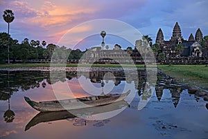 Angkor Wat reflection in lotus pond with boat on sunset, twilight, Siem Reap, Cambodia