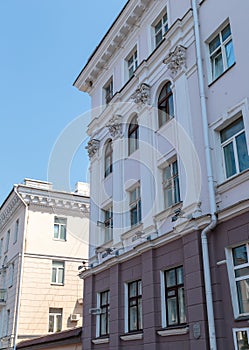 The angle of the facade of the old building that was built 100 years ago against the backdrop of the blue sky. The