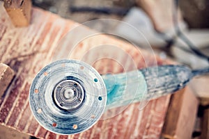 Angle grinder on construction site for cutting bricks, debris. Tools and bricks on new building site