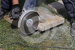 Angle grinder cutting bricks at a construction site