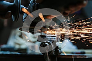 Angle grinder is cutting metal with sparks