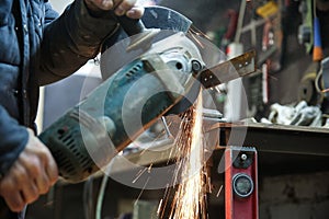 Angle grinder is cutting metal with sparks