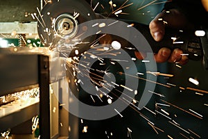 Angle grinder is cutting metal with sparks