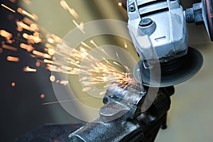 Angle grinder is cutting metal with sparks