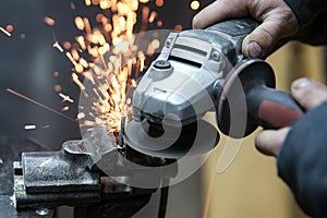 Angle grinder is cutting metal with sparks