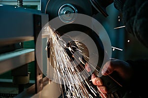 Angle grinder is cutting metal with sparks