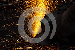 Angle grinder cutting steel with sparks spraying out