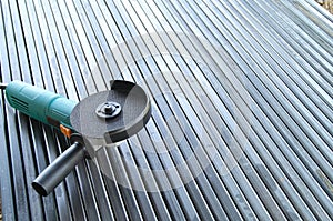 Angle grinder on metal pipes. Preparing pipes for fence construction.