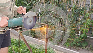 Angle Grinder Metal sawing with flashing sparks close up