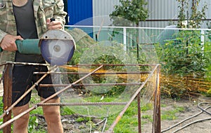 Angle Grinder Metal sawing with flashing sparks close up