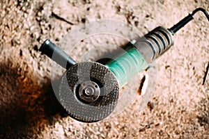 Angle grinder power tool on construction site. Details of heavy duty machinery, power tools