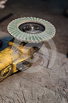 Angle grinder with rotary blade on an aluminum surface