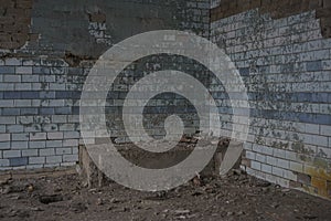 angle in industrial dirty room interior. old blue ceramic tile floor with crack texture. Concrete wall background with old