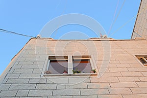 The angle of a new residential building with a window on a blue sky background