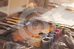 Angle view picture of an old palette with oil paints and gouache set. Clean painter workplace ready for drawing.