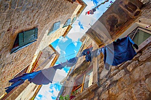 Old street in Kotor with airing clothes photo